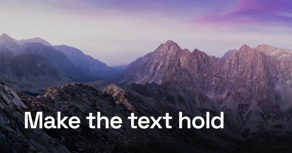 The same headline anchored on a gradient scrim along the bottom, crisp while the peaks above stay bright.